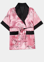 Traditionally styled fully reversible kimono with shawl collar, patch pockets and tie belt. Manufactured in a beautiful pink silky rayon/polyester with a bird of paradise and Chinese lantern print - a symbol of joy and good fortune to one side. Solid black with large dragon embroidery to reverse side.