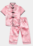 Traditionally styled pyjamas with Chinese features of mandarin collar and flower and knot frog fastenings. Manufactured in a beautiful pink silky rayon/polyester with a bird of paradise and Chinese lantern print - a symbol of joy and good fortune. Pyjama top has short sleeves, contrast bound mandarin collar and centre front opening which closes with flower and knot frog fastenings. Elasticated waist pyjama bottoms with contrast piped hem cuffs