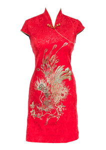 The Cheongsam or Qipao, is a feminine body-hugging dress with distinctive Chinese features of mandarin collar, side splits and hand stitched flower and knot frog fastenings. Manufactured in a striking red stretch cotton jacquard with a sequinned, gold embroidered peacock applique and gold piping. Invisible back zip