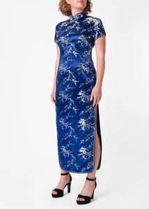 The Cheongsam or Qipao, is a feminine body-hugging dress with distinctive Chinese features of mandarin collar, side splits and flower and knot frog fastenings. Manufactured in high quality silk/rayon brocade which has a beautiful lustre. In blue with a silver cherry blossom design - a symbol of female beauty and love.