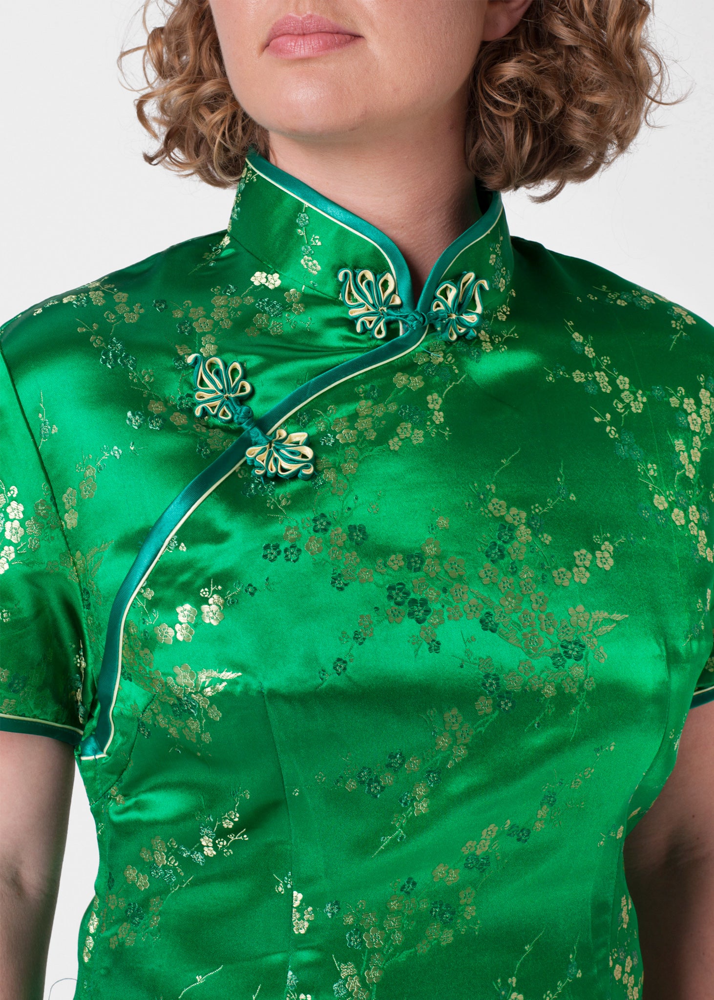 Bound edge mandarin collar and aysmmetric fastening which closes with hand stitched flower and knot frog fastenings in an accent shade. Open ended side zip and press studs