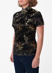 Traditional Chinese blouse in Cheongsam or Qipao style with distinctive Chinese features of mandarin collar, hand stitched flower and knot frog fastenings and side zip. Manufactured in authentic high quality silk/rayon brocade in sophisticated black with gold cherry blossom design - a symbol of female beauty and love.