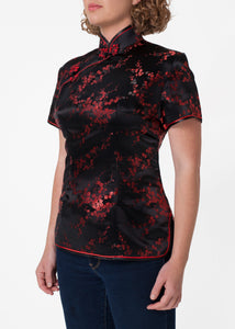 Traditional Chinese blouse in Cheongsam or Qipao style with distinctive Chinese features of mandarin collar, hand stitched flower and knot frog fastenings and side zip. Manufactured in authentic high quality silk/rayon brocade in elegant black with red cherry blossom design - a symbol of female beauty and love.